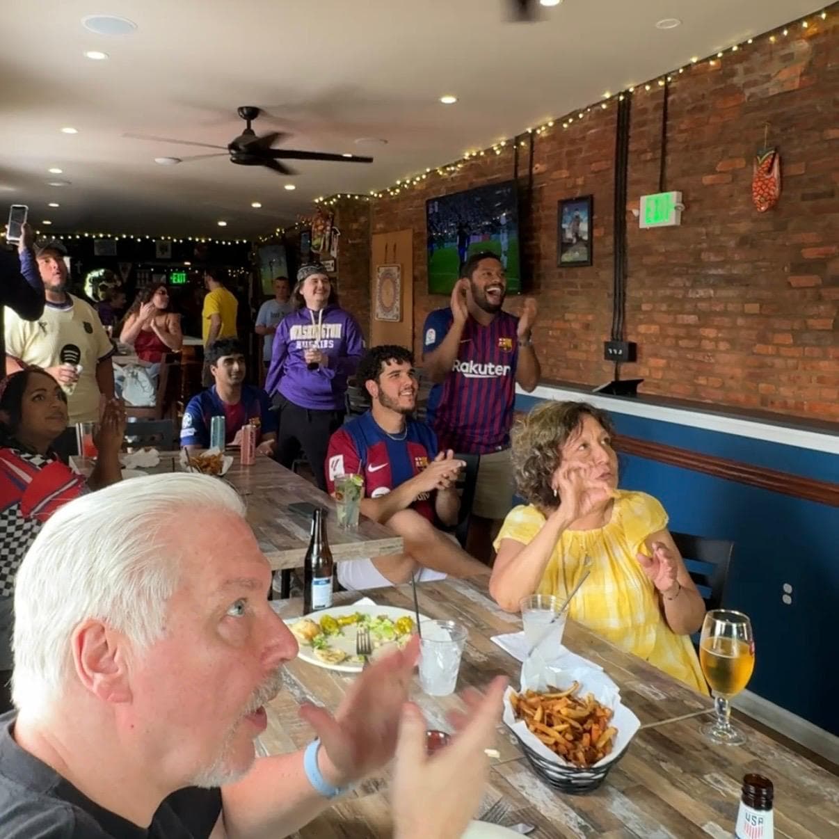 Barça fans cheering during a watch party at Barracudas