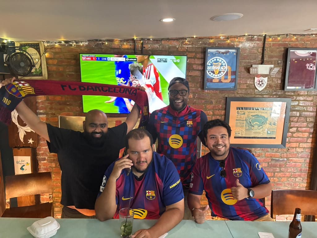 Baltimore supporters holding a Barcelona scarf on matchday