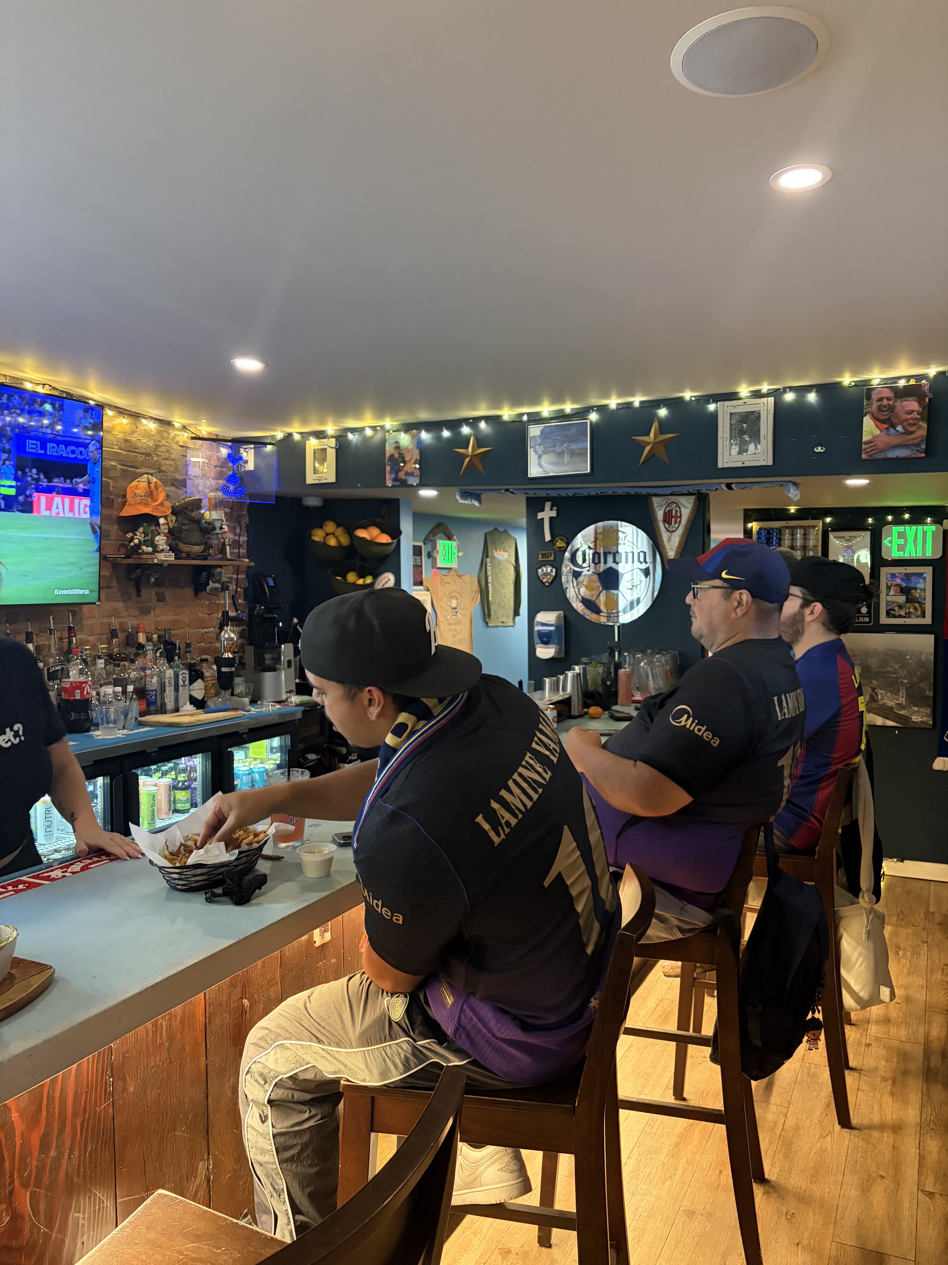 Barça supporters watching a match from the bar at Barracudas